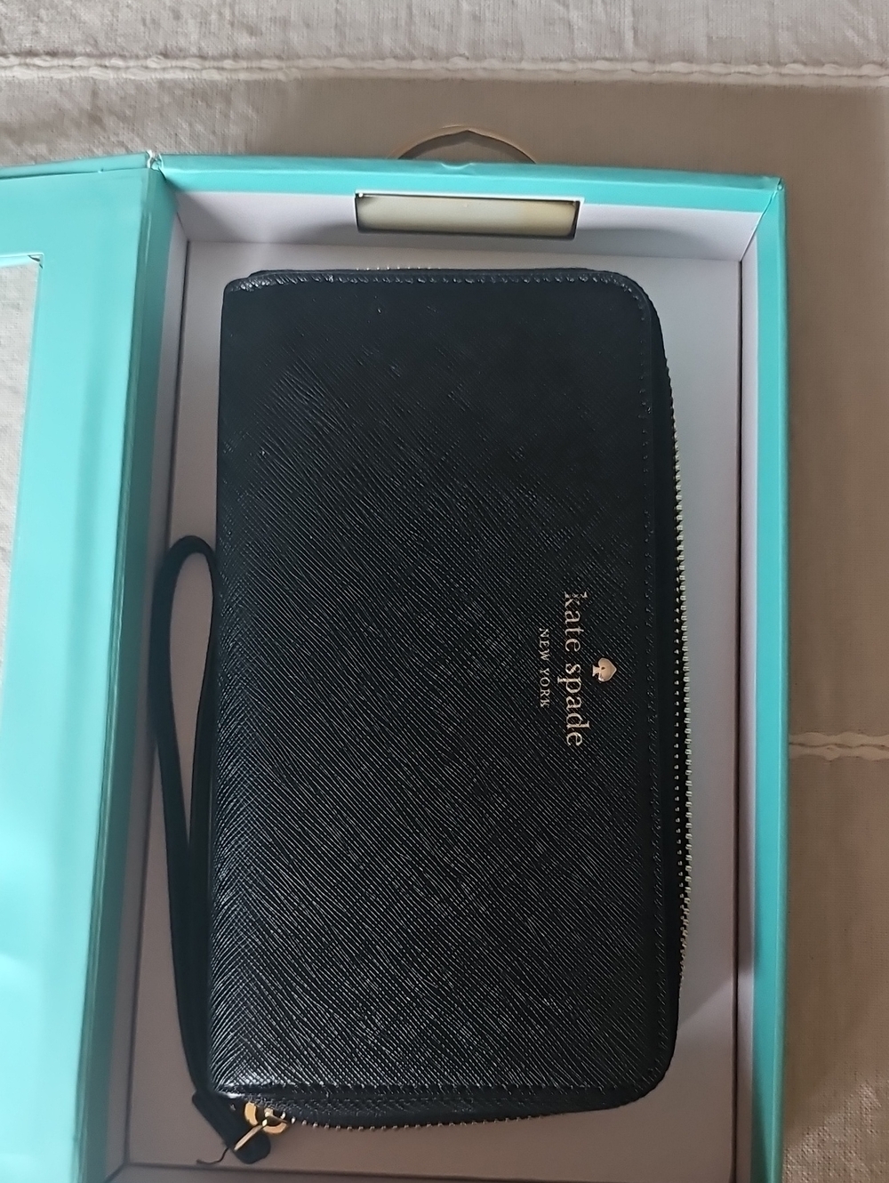kate Spade black zip-around wristlet wallet with gold logo